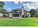 Back exterior showing a screened-in porch and well-maintained yard at 430 Tara Oaks Ct, Lawrenceville, GA 30043