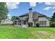 Back exterior with a screened-in porch and a well-manicured lawn at 430 Tara Oaks Ct, Lawrenceville, GA 30043
