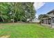 Expansive backyard with a view of the house and surrounding trees at 430 Tara Oaks Ct, Lawrenceville, GA 30043