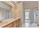 Bright bathroom with double sinks, a large mirror, and a glass-enclosed shower at 430 Tara Oaks Ct, Lawrenceville, GA 30043