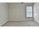 Bedroom featuring a window and neutral-toned walls and carpet at 430 Tara Oaks Ct, Lawrenceville, GA 30043