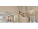 Open-concept entryway with view into kitchen, staircase, and light-colored floors at 430 Tara Oaks Ct, Lawrenceville, GA 30043