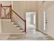 Bright foyer with hardwood floors, staircase and open doorway to the living area at 430 Tara Oaks Ct, Lawrenceville, GA 30043