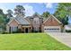 Charming two-story brick home with a well-manicured lawn and attached two-car garage at 430 Tara Oaks Ct, Lawrenceville, GA 30043