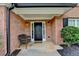 Inviting front porch with black front door, brick facade, and a cozy seating area at 430 Tara Oaks Ct, Lawrenceville, GA 30043