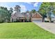 Charming brick home with a well-manicured front lawn and attached garage at 430 Tara Oaks Ct, Lawrenceville, GA 30043