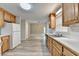 Open kitchen layout with wood-stained cabinets, stainless steel appliances, and a seamless view into the living area at 430 Tara Oaks Ct, Lawrenceville, GA 30043
