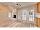 View into open concept kitchen and living room, featuring wood cabinets, and laminate flooring at 430 Tara Oaks Ct, Lawrenceville, GA 30043