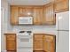 Charming kitchen features wooden cabinetry, white countertops, and a built-in microwave above the oven at 430 Tara Oaks Ct, Lawrenceville, GA 30043