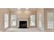 Bright living room featuring a fireplace, with three large windows for natural light at 430 Tara Oaks Ct, Lawrenceville, GA 30043