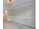 Bright, carpeted living room featuring crown molding, and large windows at 430 Tara Oaks Ct, Lawrenceville, GA 30043