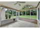 Enclosed porch with tile flooring and large windows overlooking the backyard at 430 Tara Oaks Ct, Lawrenceville, GA 30043