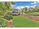 Spacious backyard featuring a tiered retaining wall and lush landscaping at 2455 Stonevalley Ln, Cumming, GA 30041