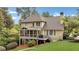 Expansive backyard showcasing a screened porch, deck, and lush greenery at 2455 Stonevalley Ln, Cumming, GA 30041