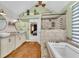 This bathroom offers a tub, shower, double sinks, and light-green painted walls at 2455 Stonevalley Ln, Cumming, GA 30041