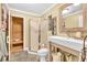 Well-maintained bathroom featuring a modern sink, toilet, and a walk-in sauna with wood paneling at 2455 Stonevalley Ln, Cumming, GA 30041