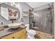 This unique bathroom features a bowl sink, granite counters, a tiled shower, and tiled floors at 2455 Stonevalley Ln, Cumming, GA 30041