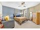This bedroom features a comfortable area for guests, a ceiling fan, and lots of light at 2455 Stonevalley Ln, Cumming, GA 30041