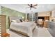 Well-lit bedroom with a comfortable bed, ceiling fan, and designer touches throughout the room at 2455 Stonevalley Ln, Cumming, GA 30041