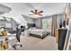 This bedroom includes a sloped ceiling, closet, comfortable chair, TV, desk, and plenty of light at 2455 Stonevalley Ln, Cumming, GA 30041