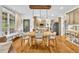 Bright dining area flows into an open kitchen, featuring hardwood floors and natural light at 2455 Stonevalley Ln, Cumming, GA 30041