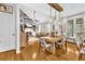 Open concept dining room with hardwood floors, stylish lighting, and a view of the living room at 2455 Stonevalley Ln, Cumming, GA 30041
