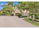 Long driveway leads to a charming home with a stone facade and meticulously maintained landscaping at 2455 Stonevalley Ln, Cumming, GA 30041