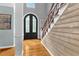 Inviting entrance area featuring stylish doors and staircase with wood accents at 2455 Stonevalley Ln, Cumming, GA 30041