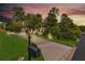 Stunning twilight view of home exterior, showing meticulous landscaping at 2455 Stonevalley Ln, Cumming, GA 30041