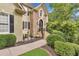 Charming home exterior with stone accents, arched entry, and manicured landscaping at 2455 Stonevalley Ln, Cumming, GA 30041