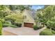 Charming home with a side-entry garage, complemented by lush landscaping at 2455 Stonevalley Ln, Cumming, GA 30041