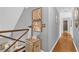 Hallway with staircase featuring rustic decor and stylish wall art at 2455 Stonevalley Ln, Cumming, GA 30041