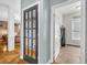 Hallway with doors and an office space visible, showcasing the home's layout at 2455 Stonevalley Ln, Cumming, GA 30041