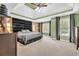 This main bedroom features vaulted ceilings, a ceiling fan, natural light, and an accent wall at 2455 Stonevalley Ln, Cumming, GA 30041