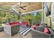 Beautiful screened-in patio featuring comfortable wicker furniture, wood floors and ceiling fan at 2455 Stonevalley Ln, Cumming, GA 30041