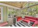 Inviting screened-in patio with wicker seating, ceiling fan, and peaceful outdoor views at 2455 Stonevalley Ln, Cumming, GA 30041