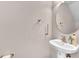Bathroom featuring a mirror, a sink, and wall mounted accessories at 3028 Sw Deerborne Court Sw Ct, Atlanta, GA 30331