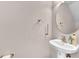 Bathroom with a pedestal sink, round mirror, and bronze fixtures at 3028 Sw Deerborne Court Sw Ct, Atlanta, GA 30331
