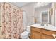 Bathroom featuring a shower with floral curtain, toilet, vanity, and a mirror at 3028 Sw Deerborne Court Sw Ct, Atlanta, GA 30331