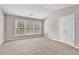 Bright bedroom featuring neutral walls, carpet, a large window, and a closet door at 3028 Sw Deerborne Court Sw Ct, Atlanta, GA 30331