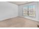 Bright bedroom features a large window and neutral carpet at 3028 Sw Deerborne Court Sw Ct, Atlanta, GA 30331