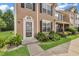 Charming townhouse exterior with landscaped entrance, walkway, and black shutters at 3028 Sw Deerborne Court Sw Ct, Atlanta, GA 30331
