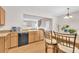 Clean kitchen with breakfast bar overlooking the living area, featuring modern appliances at 3028 Sw Deerborne Court Sw Ct, Atlanta, GA 30331