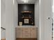 Stylish built-in bar area with floating shelves, attractive decor, and ample storage at 630 Brashy St, Woodstock, GA 30188
