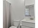 Clean bathroom with gray curtain, a white vanity, and a well-lit mirror at 630 Brashy St, Woodstock, GA 30188