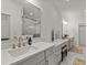 Bathroom featuring double sink vanity, a large framed mirror, and recessed lighting at 630 Brashy St, Woodstock, GA 30188