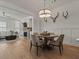 Open dining area with a round table, stylish light fixture, and view of the living area at 630 Brashy St, Woodstock, GA 30188
