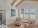 Cozy dining area featuring a vaulted ceiling, exposed beams, and stainless steel refrigerator at 630 Brashy St, Woodstock, GA 30188