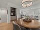 Elegant dining area with wood table, pendant lighting, and views to the living room at 630 Brashy St, Woodstock, GA 30188