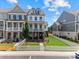 Charming townhome showcasing a manicured front yard, white picket fence and lovely brick and siding elevation at 630 Brashy St, Woodstock, GA 30188